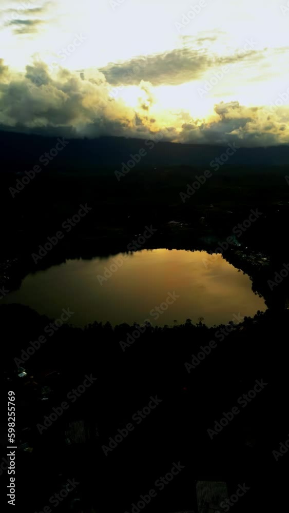 Aerial view of the lake in the middle of a plantation and evening clouds Aerial view of the lake in the middle of a plantation and evening clouds
