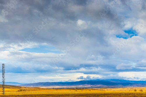 Autumn fall landscape in Kakheti region  Georgia. Beautiful view on fields and vinegroves. Dramatic sky. Mountains in the background.