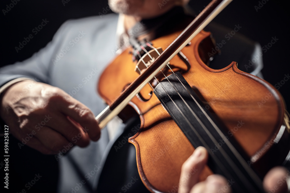Violinist player hands playing violin performing in an orchestra Violinist player hands playing violin performing in an orchestra