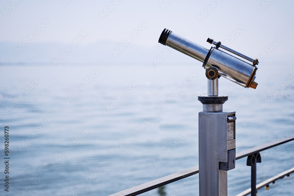 Coin Operated Spyglass viewer next to the waterside promenade looking out to the bay. Coin Operated Spyglass viewer next to the waterside promenade looking out to the bay.