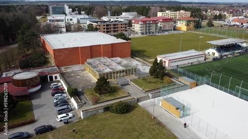 Outdoor sports ground and covered hall for indoor sports. Drone, small town. photo