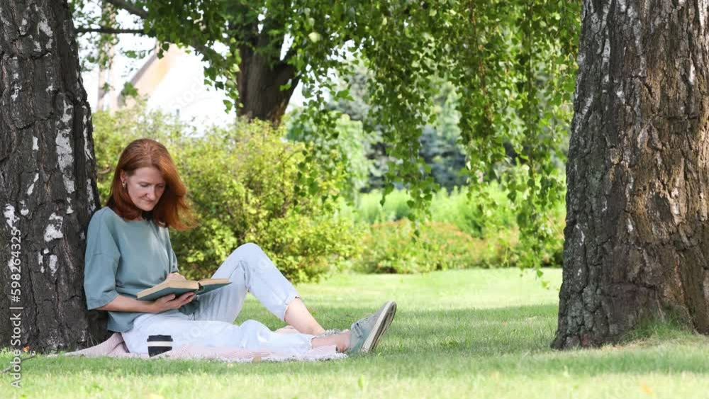 woman reading in a park woman reading in a park