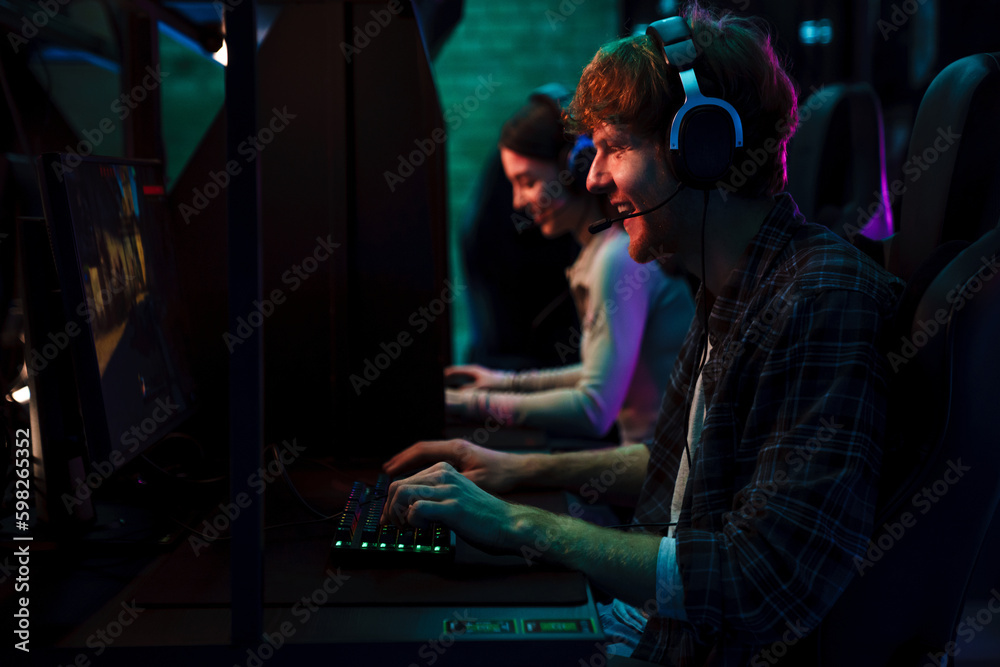 Team of gamers playing video game in cybersport club