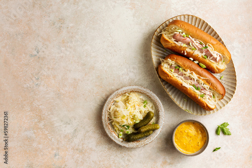 Traditional grilled beef hot dogs with sauerkraut and mustard sauce.