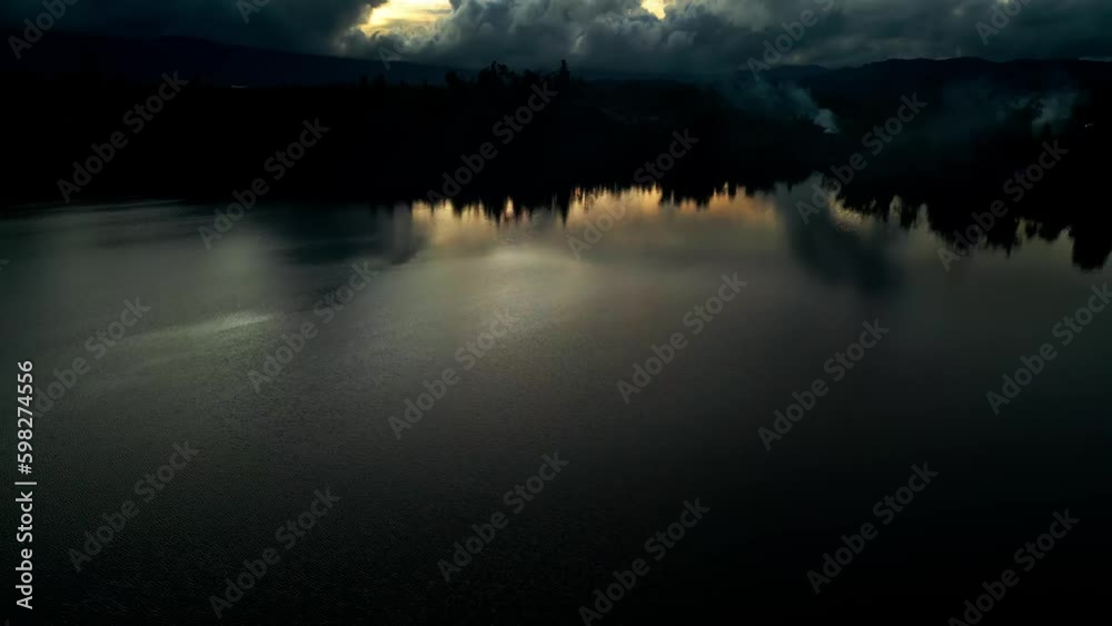 Aerial view of the lake in the middle of a plantation and evening clouds Aerial view of the lake in the middle of a plantation and evening clouds