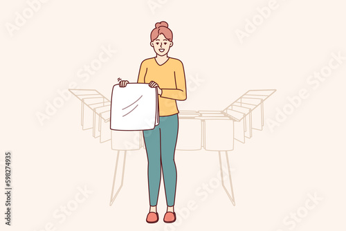 Woman housewife stands near dryer with clean towels doing household chores to create comfort in apartment. Housewife girl with washed item for advertising washing powder or aromatic Generative AI