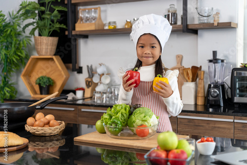 Little Chef girl preparing healthy food in kitchen