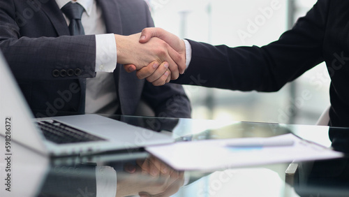 man Manager welcomes the client with a handshake.
