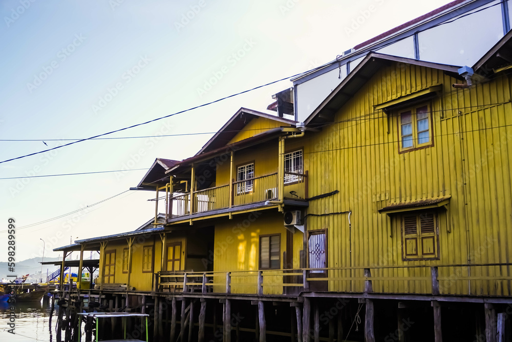 Traditional floating houses or houses on stilts for the Sumatran people built on shallow waters. Wooden stage house in coastal areas, Tarempa, Anambas Islands, Indonesia.