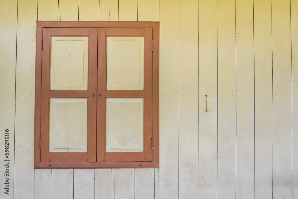 Closed Old wooden window with shutters on an wooden wall. Window on indonesian malay traditional house. Sumatran traditional house. Empty Blank Text Space. Closed Old wooden window with shutters on an wooden wall. Window on indonesian malay traditional house. Sumatran traditional house. Empty Blank Text Space.