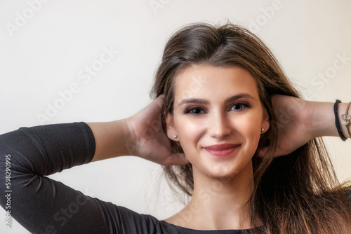 Portrait of smiling happy beautiful girl on light background. closeup. Horizontally. 