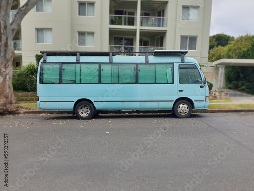 side view of blue van parked on the street