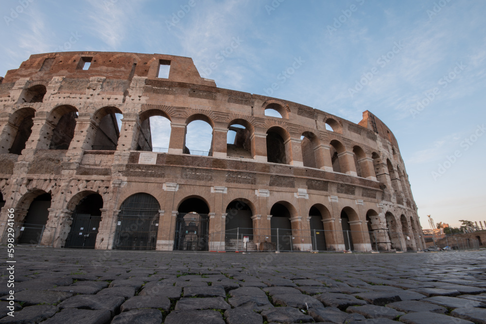 Rome, Italy - Close up of the Coliseum at sunrise, low angle, cobblestones