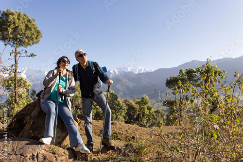 Happy senior couple hiking on the mountain.