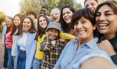 Group of multigenerational people taking selfie with phone camera - Multiracial friends of different ages having fun together - Main focus on asian woman face