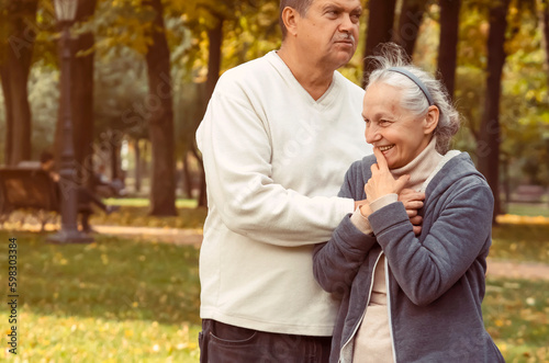 Happy retired couple, a man and a woman walk together.