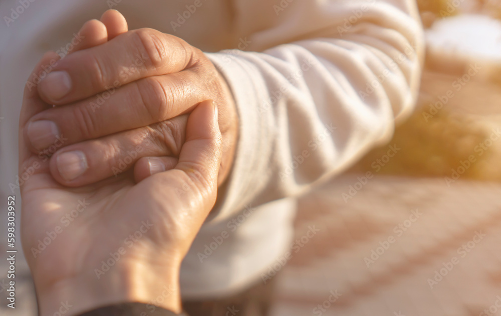 A man holds a hand of his beloved wife, a couple together. A man holds a hand of his beloved wife, a couple together.