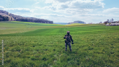 Modern army soldiers using aerial drone for artillery guidance and scouting view enemy positions in military operation. 