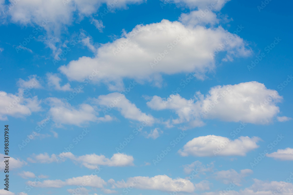 Beautiful white fluffy cloud floating in blue sky in sunny day, Cumulus are clouds which have flat bases and are often described as puffy, Horizon nature background with free copy space.