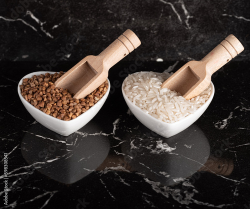 Rice grains and rice grains in bowls. Beautiful black background. View from above