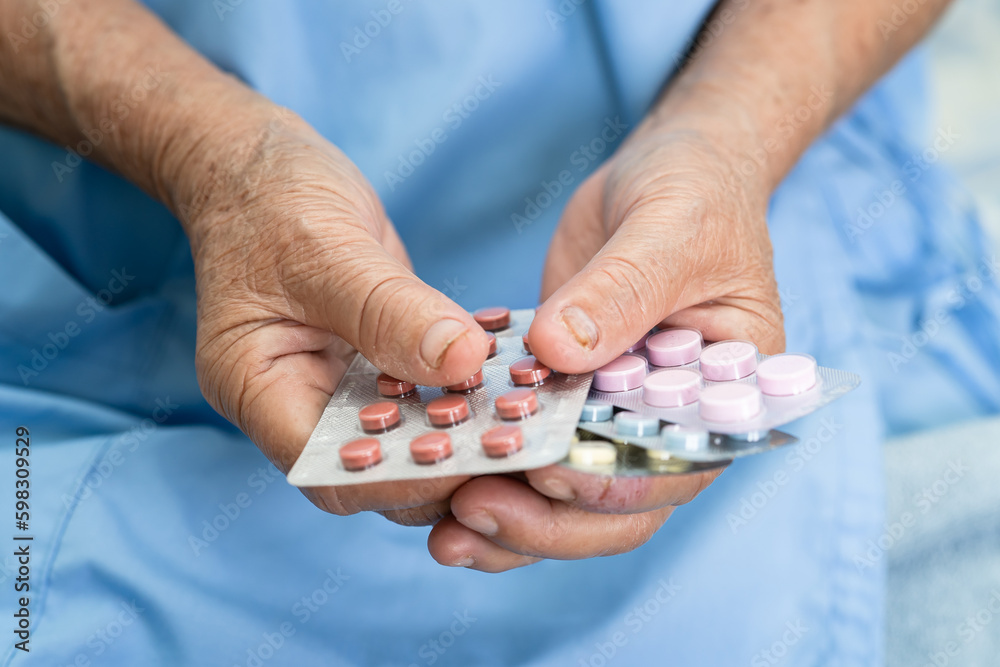 Asian elderly woman patient holding drug in her hand, healthy strong medical concept. Asian elderly woman patient holding drug in her hand, healthy strong medical concept.
