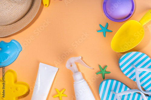 Kids, children, baby and sun protection, uv-protecting skin care sunblock cosmetics. Sun screen SPF bottle cream, sunglasses, panama hat, sand molds toys on sunny beige background