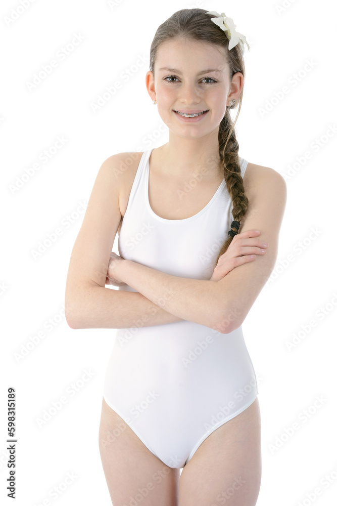Happy smiling teenage girl with braided pigtail poses in white one-piece swimsuit in in studio isolated on white Happy smiling teenage girl with braided pigtail poses in white one-piece swimsuit in in studio isolated on white