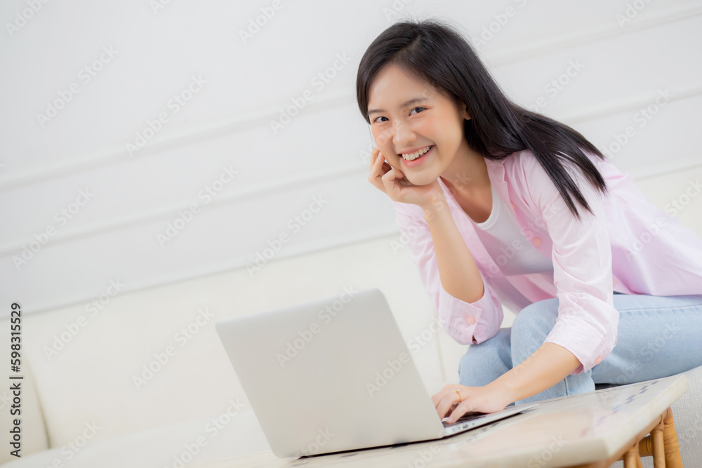 Young asian business woman work from home with laptop computer online to internet on sofa in living room, freelance girl using notebook sitting on couch with comfort and relax, lifestyles concept. Young asian business woman work from home with laptop computer online to internet on sofa in living room, freelance girl using notebook sitting on couch with comfort and relax, lifestyles concept.