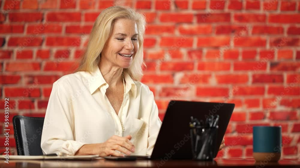 Happy old senior mature woman video conference calling talking enjoying social distance party, virtual family online chat meeting with children or friends using laptop computer at home. Generative AI