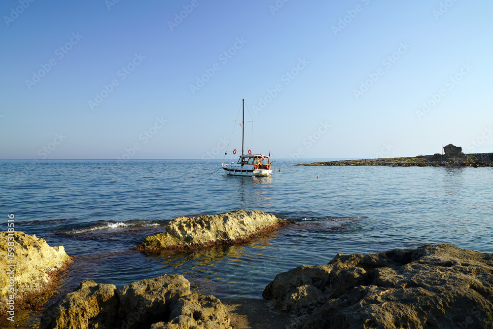 A small yacht moored off the shore A small yacht moored off the shore