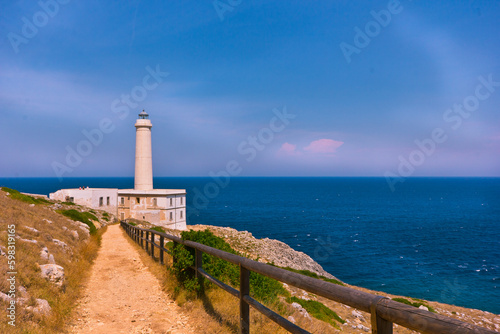 lighthouse on a rock coast looking at the horizon 