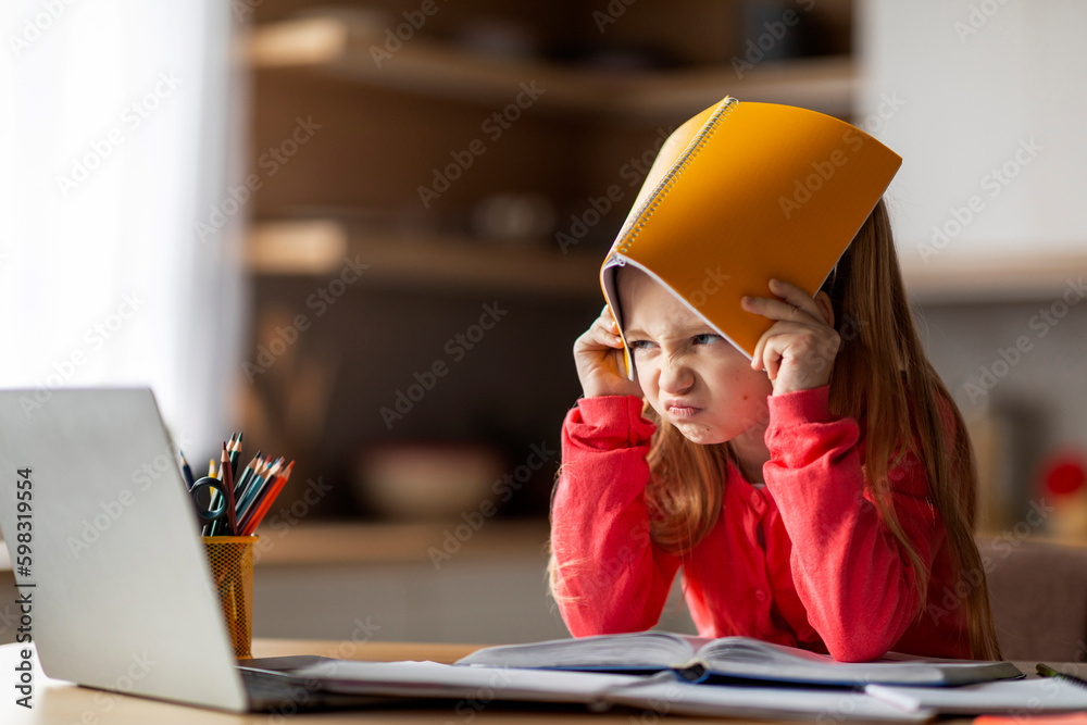 Learning Difficulties. Irritated Little Girl Covering Head With Workbook At Home Generative AI - obrazy, fototapety, plakaty 