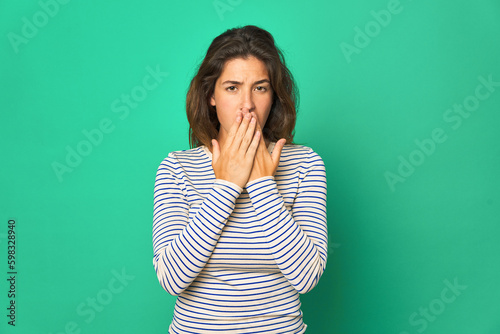 Young caucasian woman isolated shocked, covering mouth with hands, anxious to discover something new.