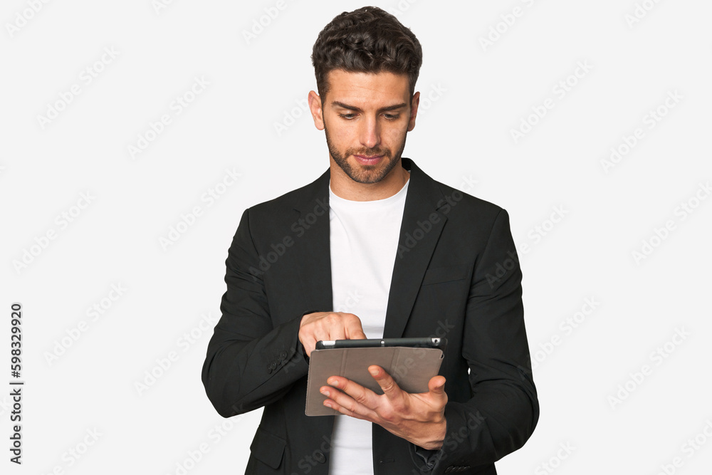 Young businessman excelling in his work, utilizing a tablet with modern technology for enhanced productivity and organization. Young businessman excelling in his work, utilizing a tablet with modern technology for enhanced productivity and organization.