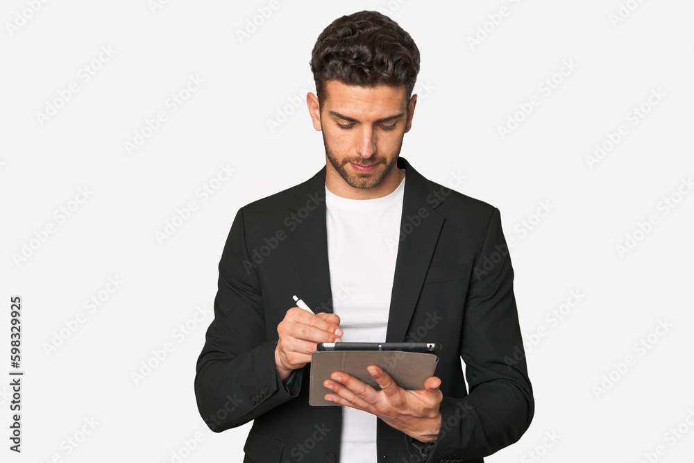Young businessman excelling in his work, utilizing a tablet with modern technology for enhanced productivity and organization. Young businessman excelling in his work, utilizing a tablet with modern technology for enhanced productivity and organization.