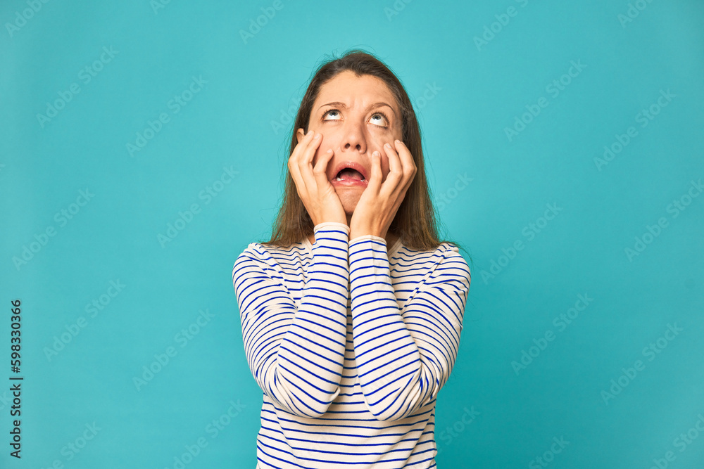A young caucasian woman isolated whining and crying disconsolately. A young caucasian woman isolated whining and crying disconsolately.
