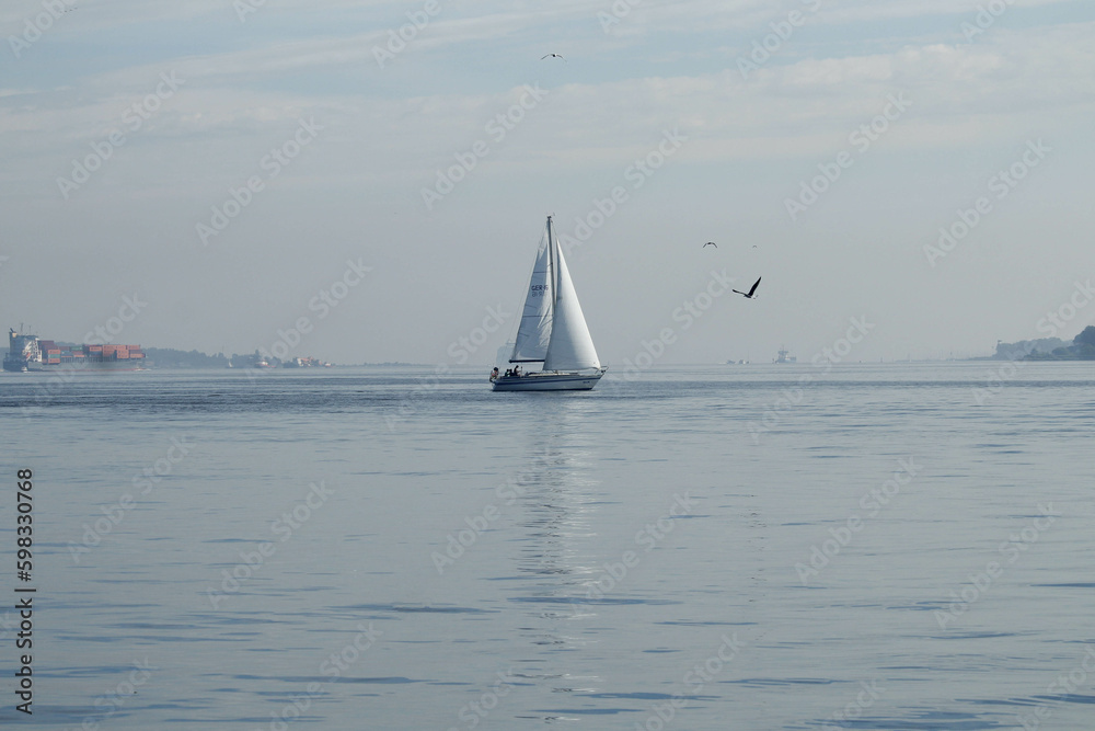 Obraz premium Sailboat at sea on a summer day against the blue sky