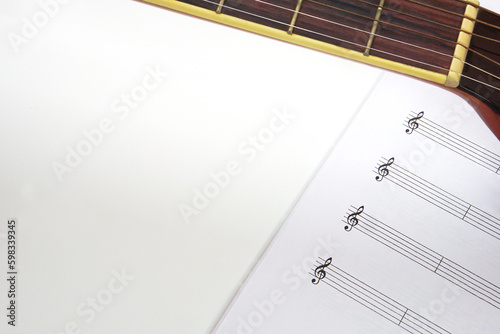 The acoustic guitar neck and musical notes on white background. Love, music and learning concept.