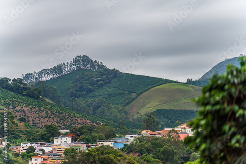 Green Valley Village with Coffee Plantations and Mountain Range