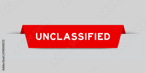 Red color inserted label with word unclassified on gray background