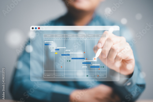 Project management or Engineering proceeding concept. Site manager working with Gantt chart schedule for plan tasks and progress. Planning software. Corporate strategy for construction and operations. photo
