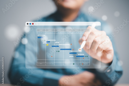 Project management or Engineering proceeding concept. Site manager working with Gantt chart schedule for plan tasks and progress. Planning software. Corporate strategy for construction and operations.