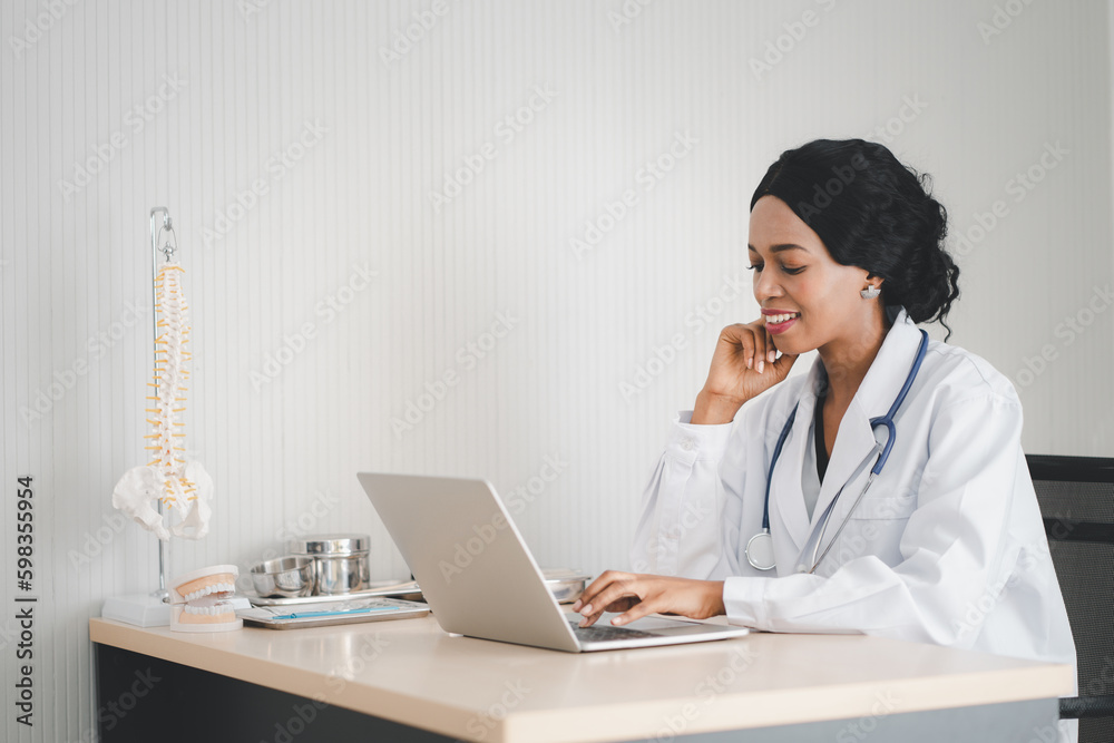 african woman doctor in headset taking calling on her headset microphone online for a ache patient african woman doctor in headset taking calling on her headset microphone online for a ache patient