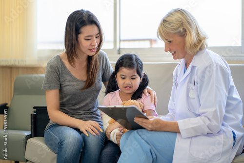 Pediatrician is closely caring and asking about sick girls symptoms, health concepts and child care.