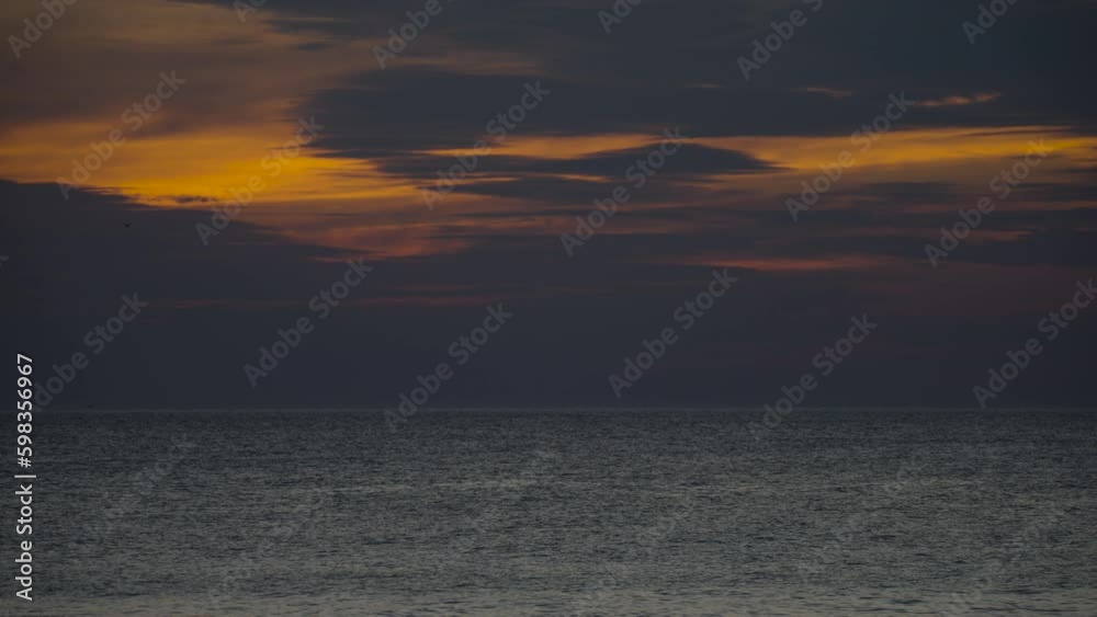 Sunrise Trying To Appear Over Calm Sea Behind Dark Clouds Sunrise Trying To Appear Over Calm Sea Behind Dark Clouds