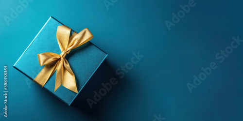 Luxurious Gold Present Box with Ribbon on Blue Background