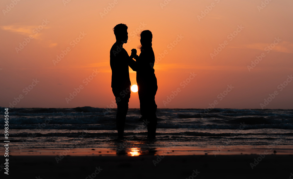 Couple Appreciation Day concept image, lovers enjoying the sunset view from the beach