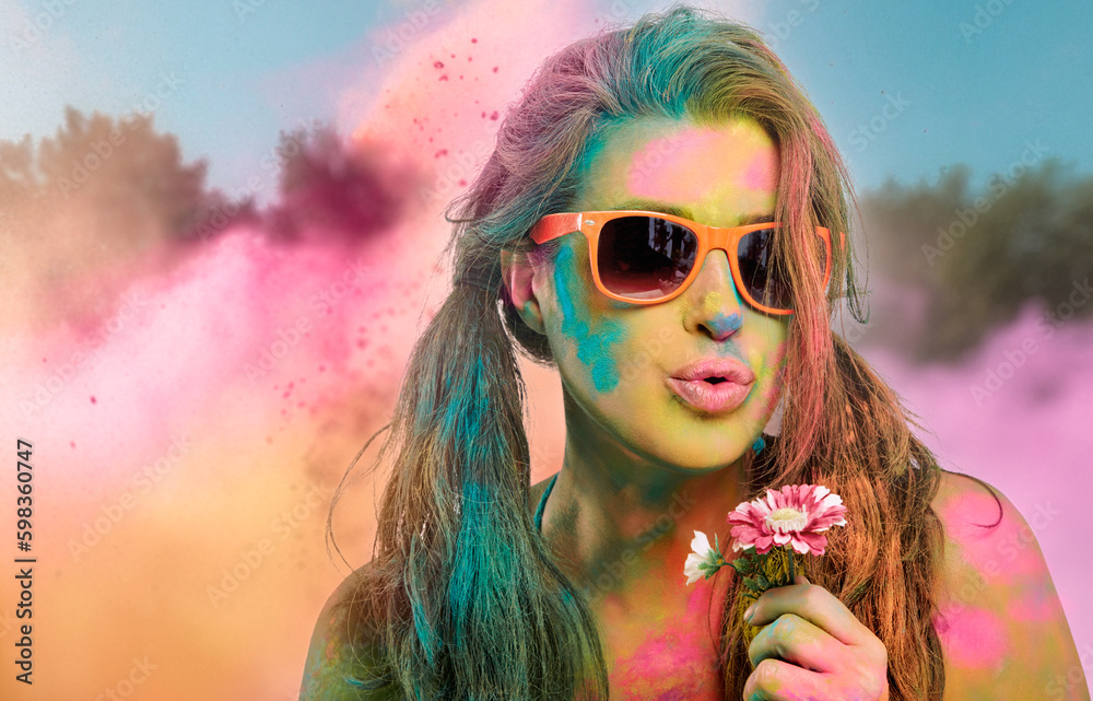 Beautiful young woman covered in rainbow colored powder. Festival of colors. Beauty spring concept Beautiful young woman covered in rainbow colored powder. Festival of colors. Beauty spring concept