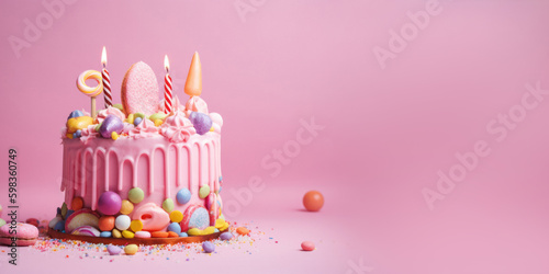 Colorful Birthday Cake with Frosting and Candy on Pastel Pink Background