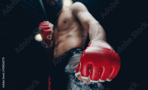 Concept kickboxing sport banner, dark color. Closeup red Gloves for MMA of Boxers fighter in octagon